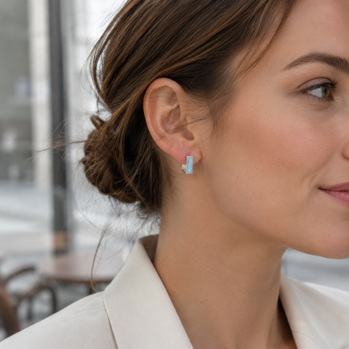 Close ear view of a Silver French enamel drop stud earring