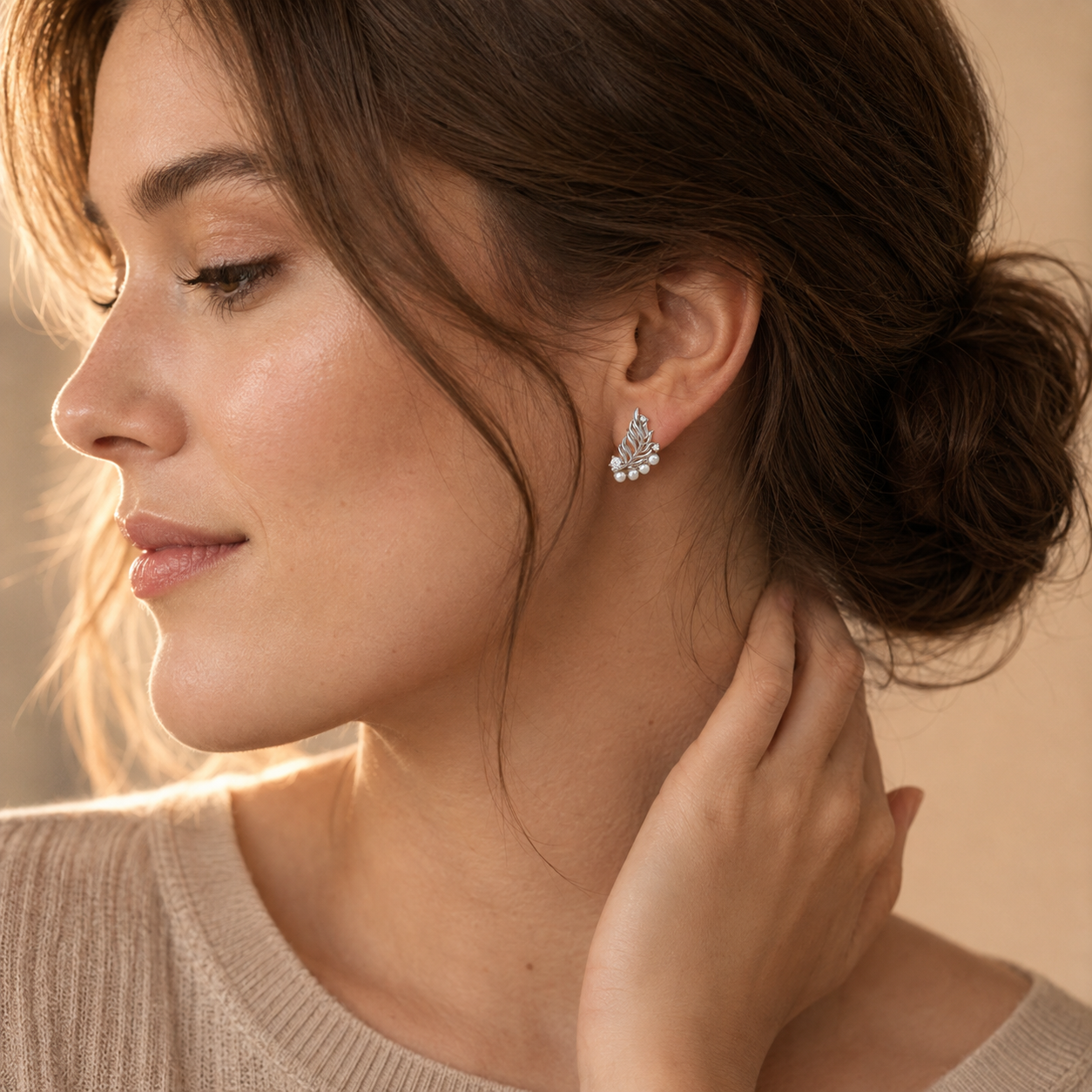 Close ear view of Silver feather pearl stud earring