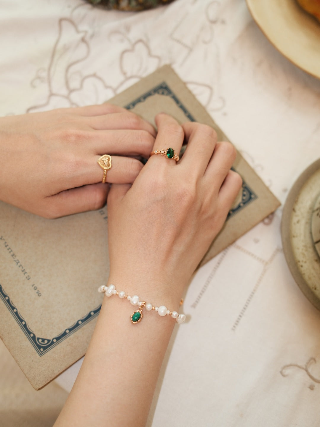 Vintage Gold natural pearl and malachite Fu bracelet styled in warm daylight