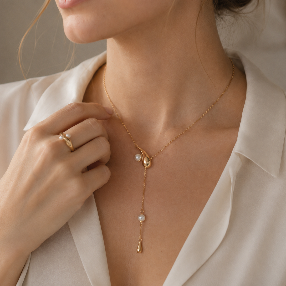 Woman wearing Vintage Gold pearl meteor drop necklace