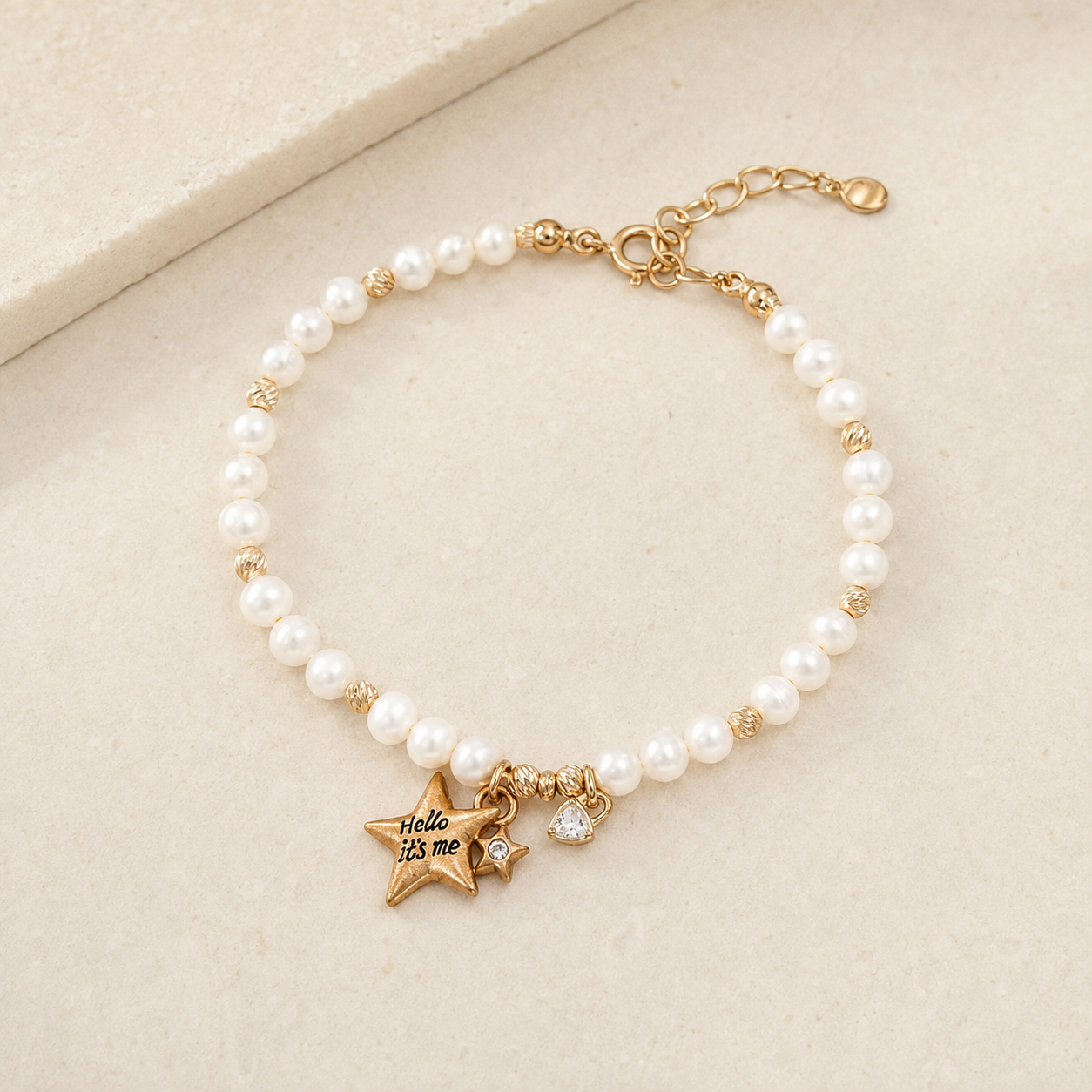 Vintage Gold natural pearl star charm bracelet on a stone display