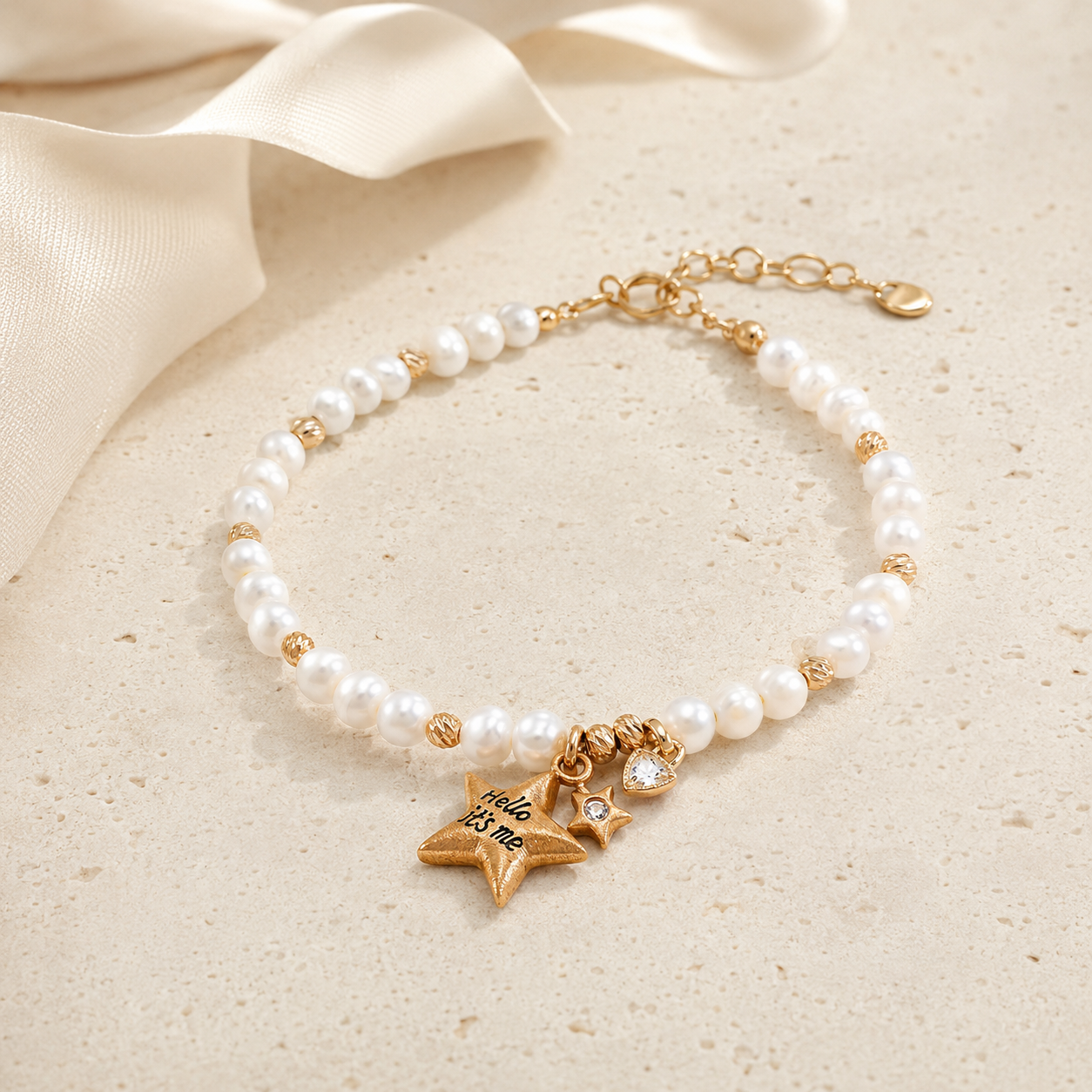 Vintage Gold natural pearl star charm bracelet styled with an ivory ribbon