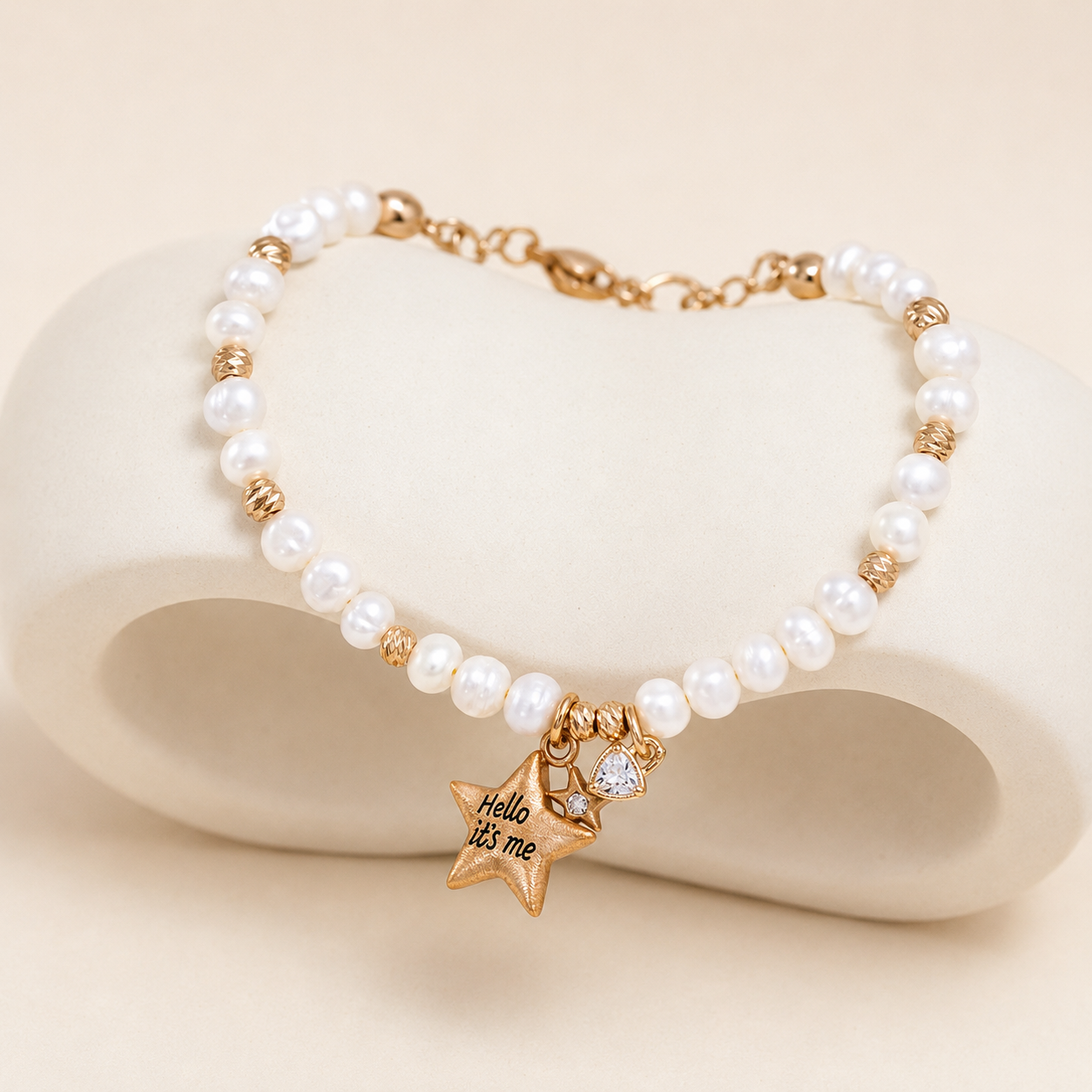 Vintage Gold pearl star charm bracelet on a sculpted ivory display