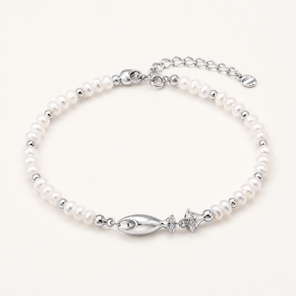 Silver natural pearl fish bracelet on a white background