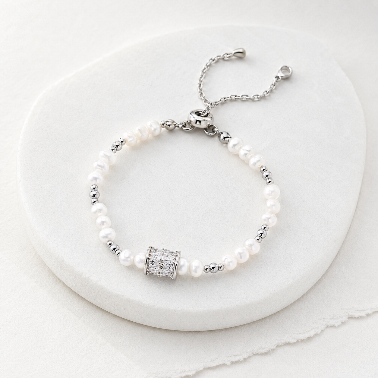 Silver Fortune Turn Pearl Bracelet on a marble display