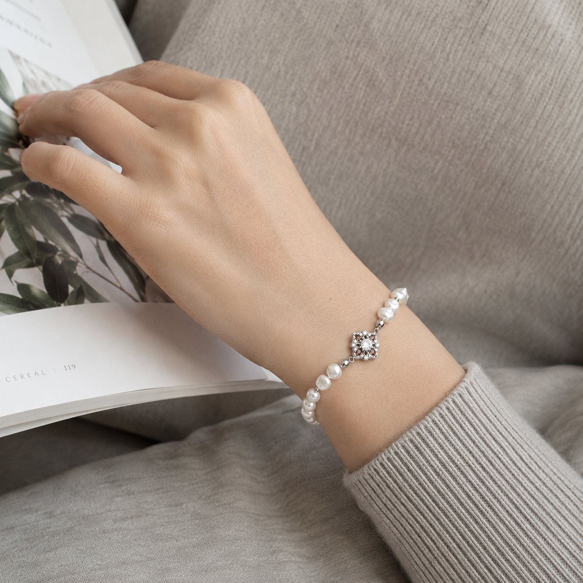 Close wrist view of the Silver floral natural pearl bracelet
