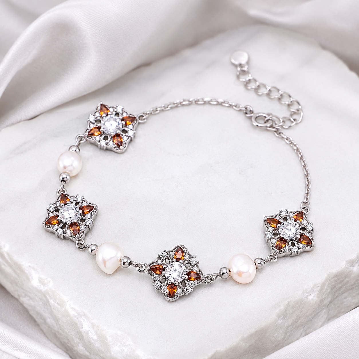 Silver auspicious bloom natural pearl bracelet on an ivory display