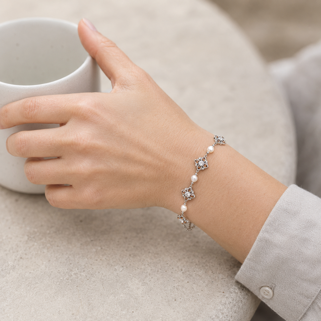 Close wrist view of the Silver auspicious bloom natural pearl bracelet
