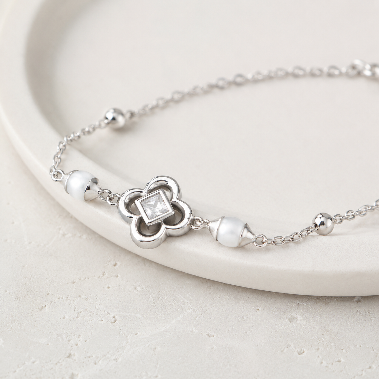 Close-up of Silver clover shell and zircon bracelet
