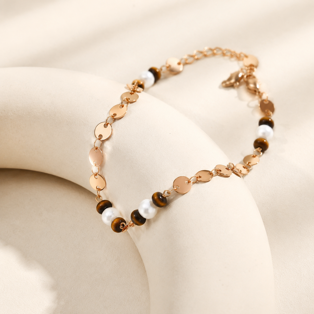 Close view of the Vintage Gold tiger eye, pearl, and disc-link bracelet