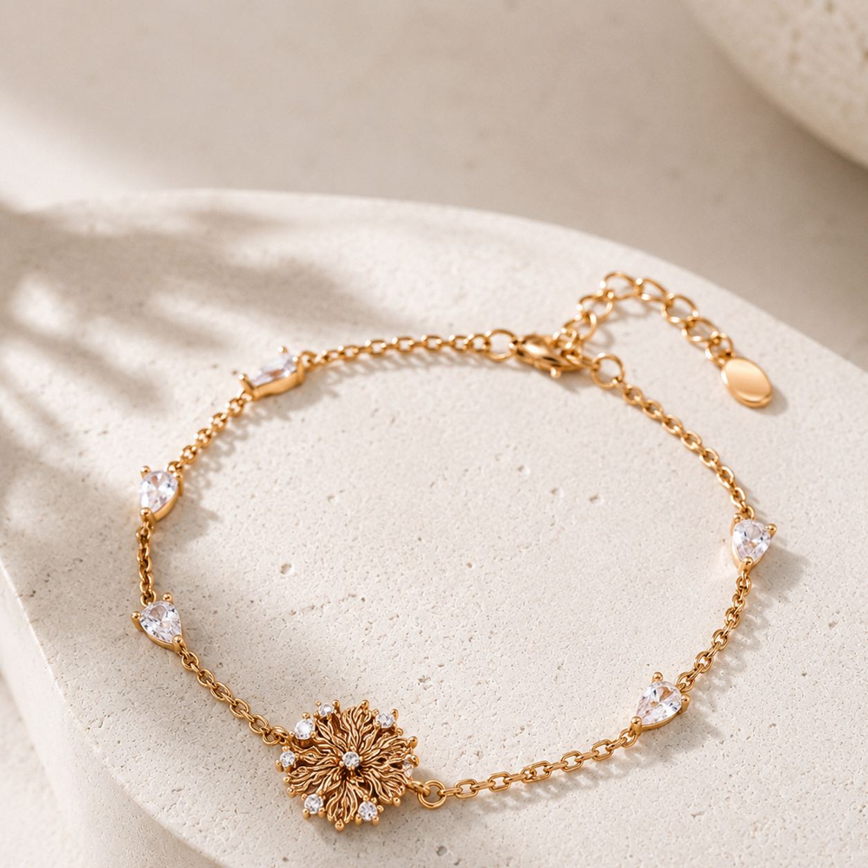 Six-Petal Lily Bracelet in Vintage Gold with cubic zirconia on a stone display