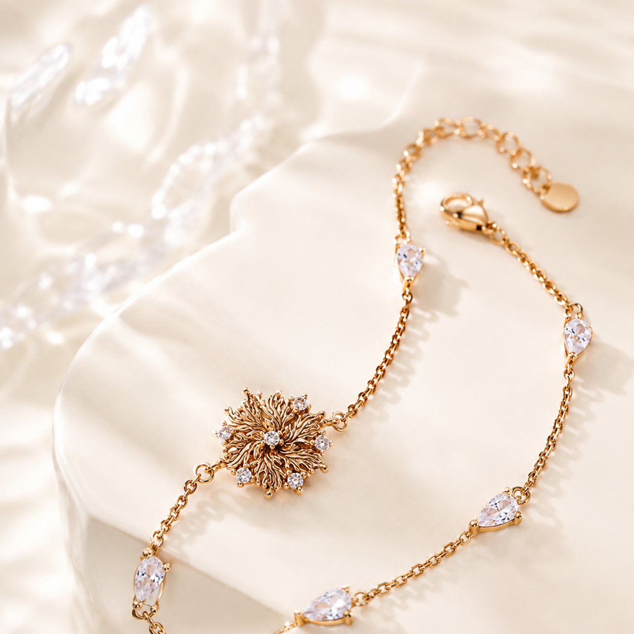 Six-Petal Lily Bracelet in Vintage Gold arranged on an ivory display
