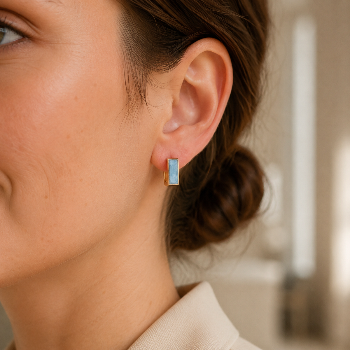 Close ear view of a Vintage Gold French enamel drop stud earring
