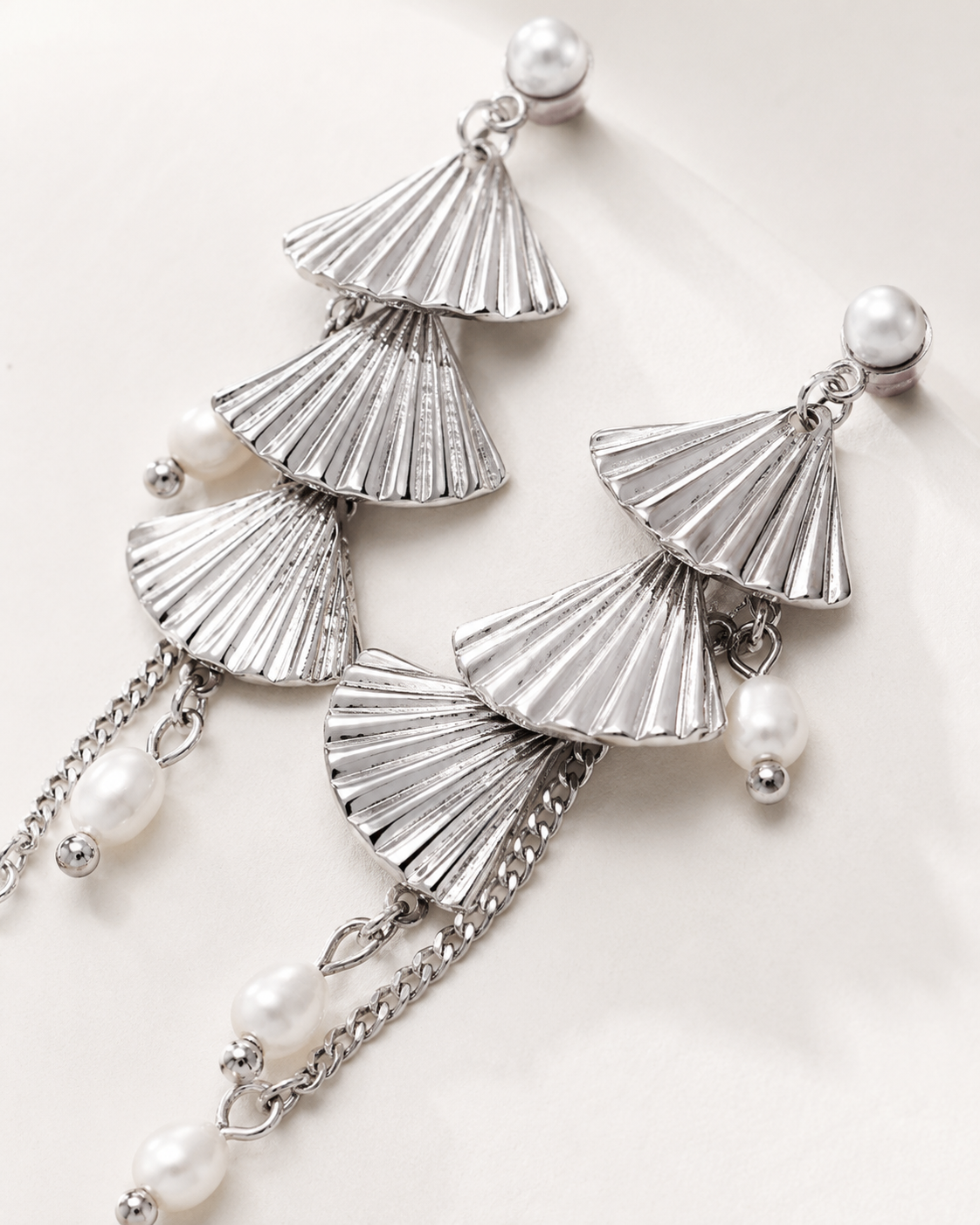 White gold layered fan natural pearl earrings close-up