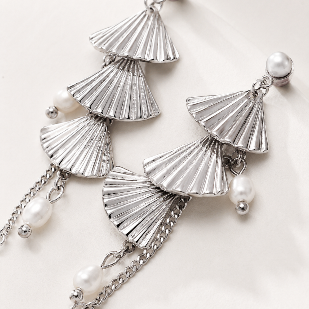 Silver layered fan natural pearl earrings close-up