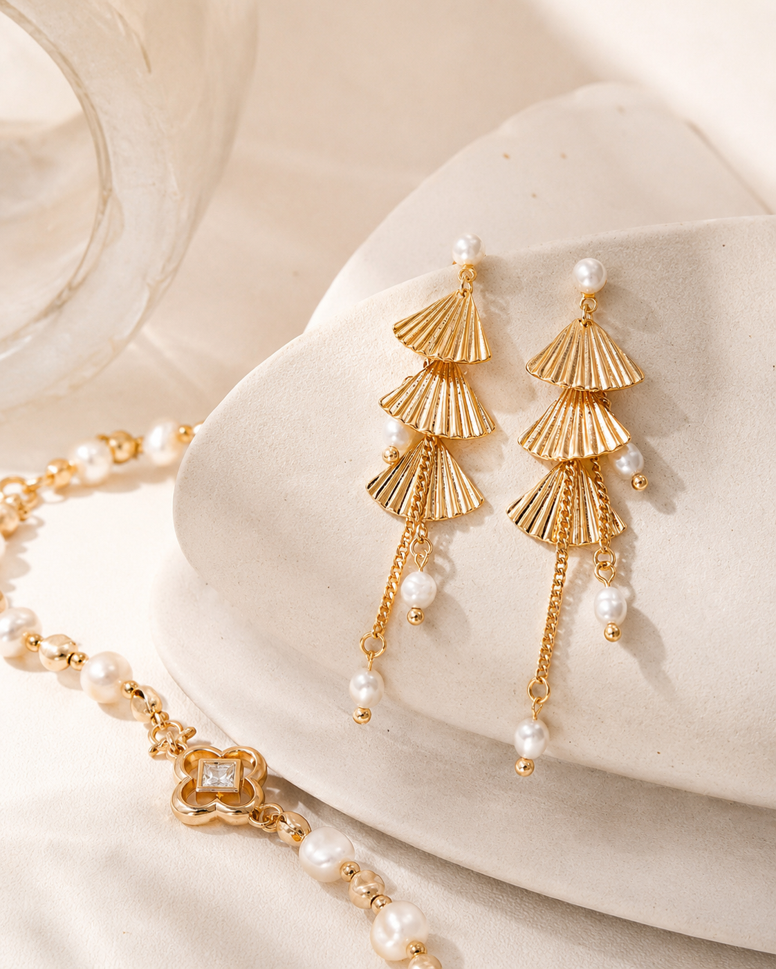 Vintage gold pearl fan earrings styled with coordinating bracelet