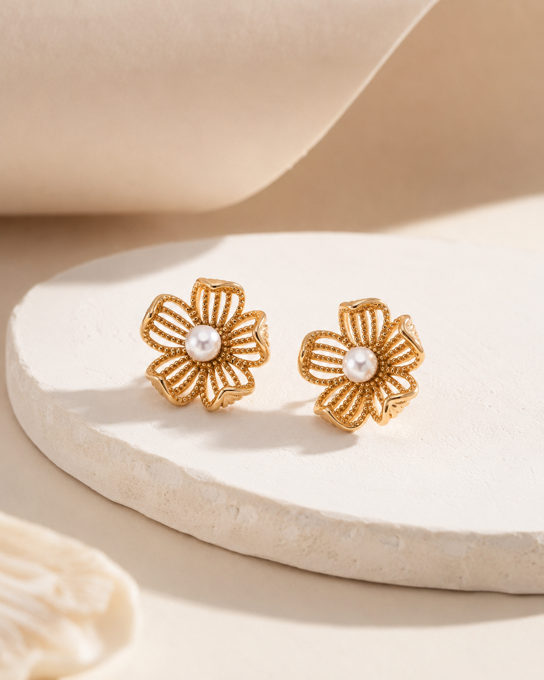 Vintage Gold floral pearl stud earrings on a neutral display