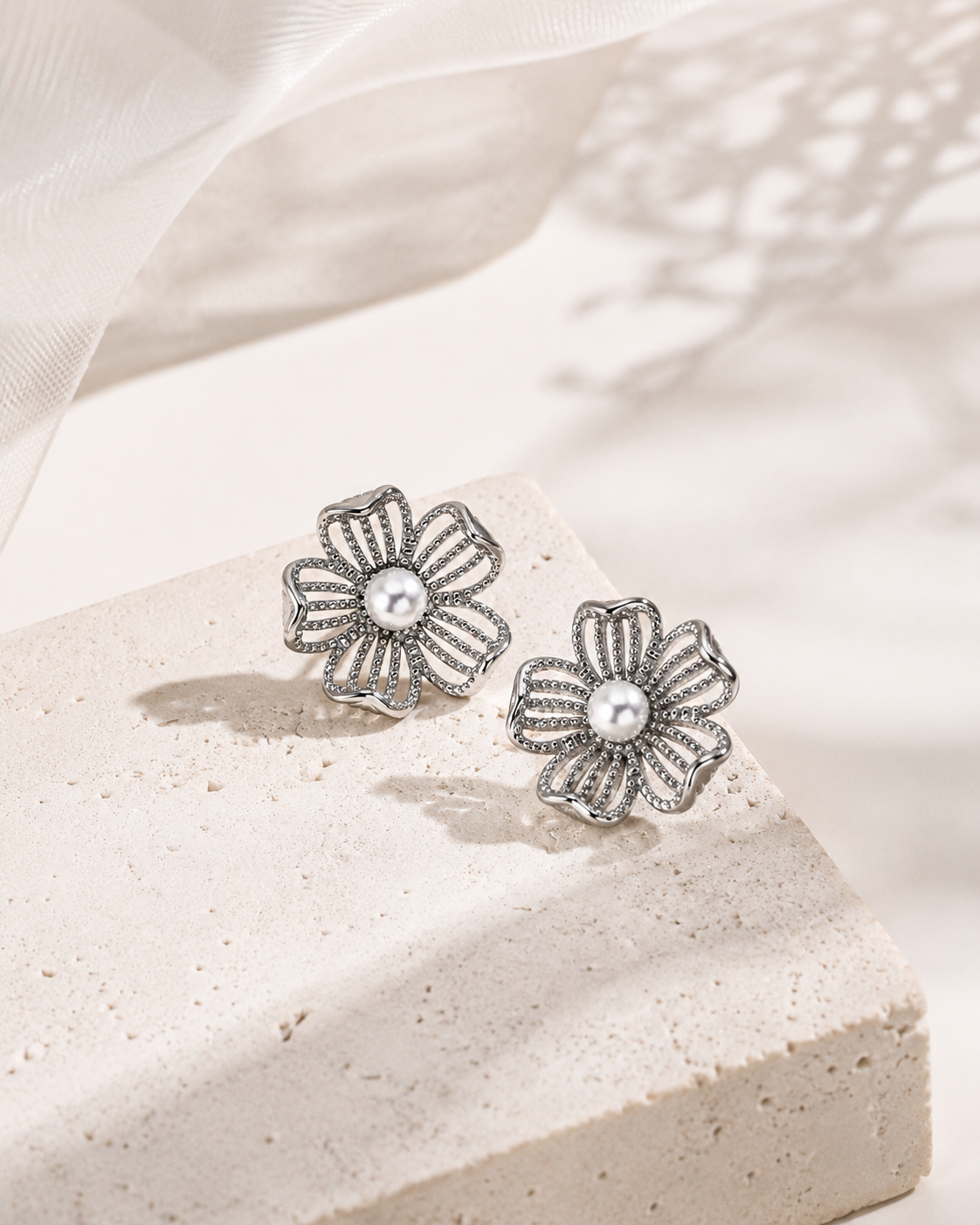 Silver openwork flower earrings with natural pearl centers