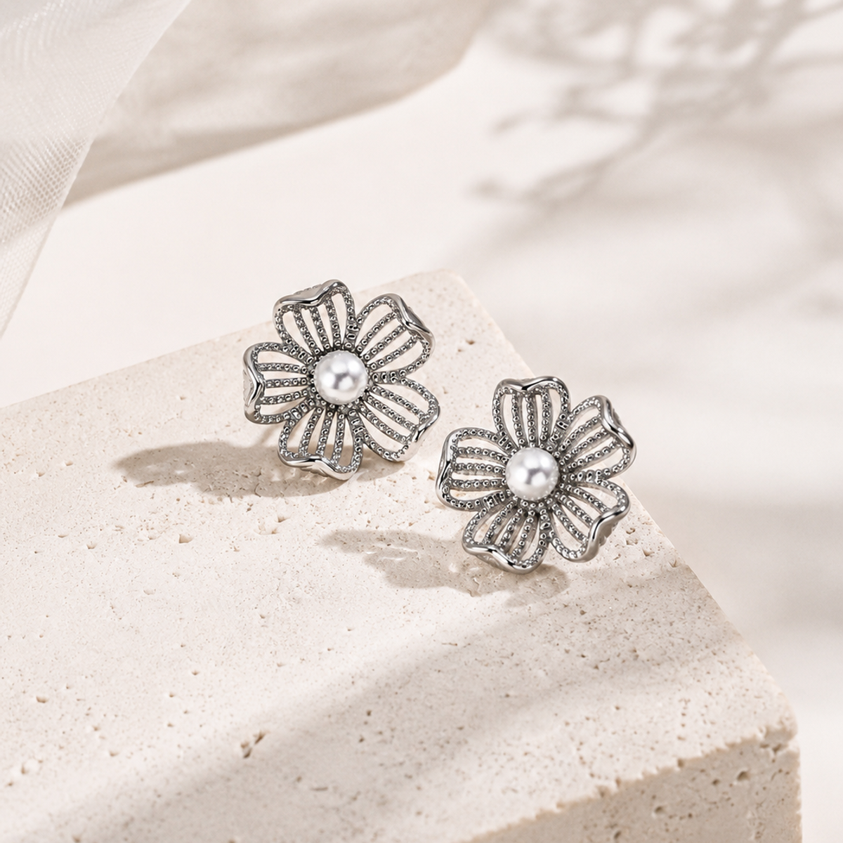 Silver openwork flower earrings with natural pearl centers