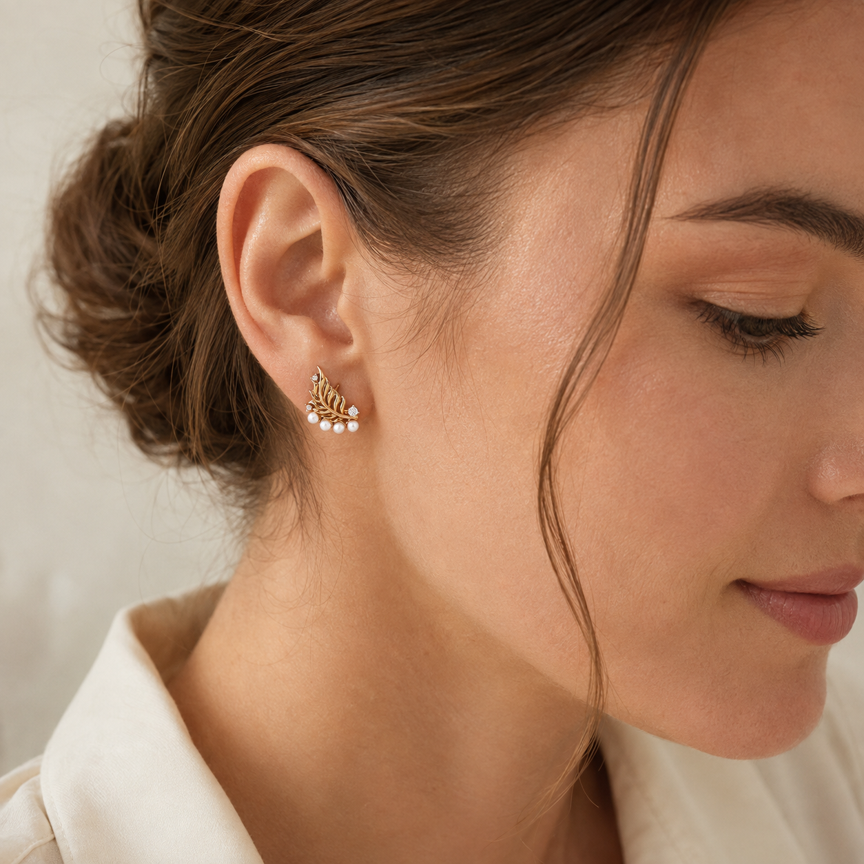 Close ear view of Vintage Gold feather pearl stud earring