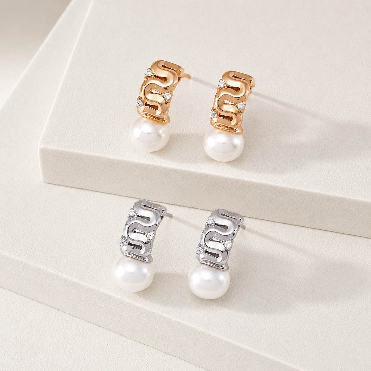Vintage Gold and Silver pearl ribbon stud earrings with cubic zirconia on a display
