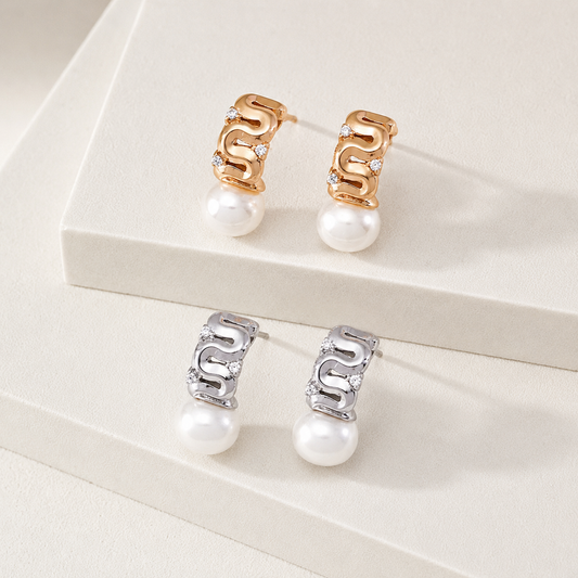 Vintage Gold and Silver pearl ribbon stud earrings with cubic zirconia on a display