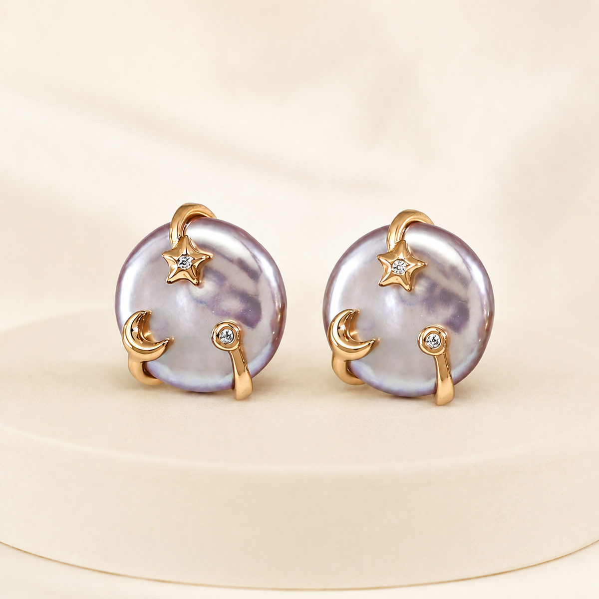 Pair of Vintage Gold Wish Pearl Earrings on an ivory display