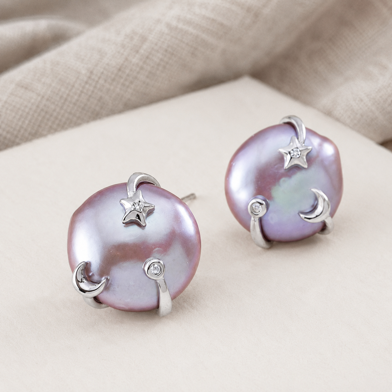 Close product view of Silver Wish Pearl Earrings with moon and star details