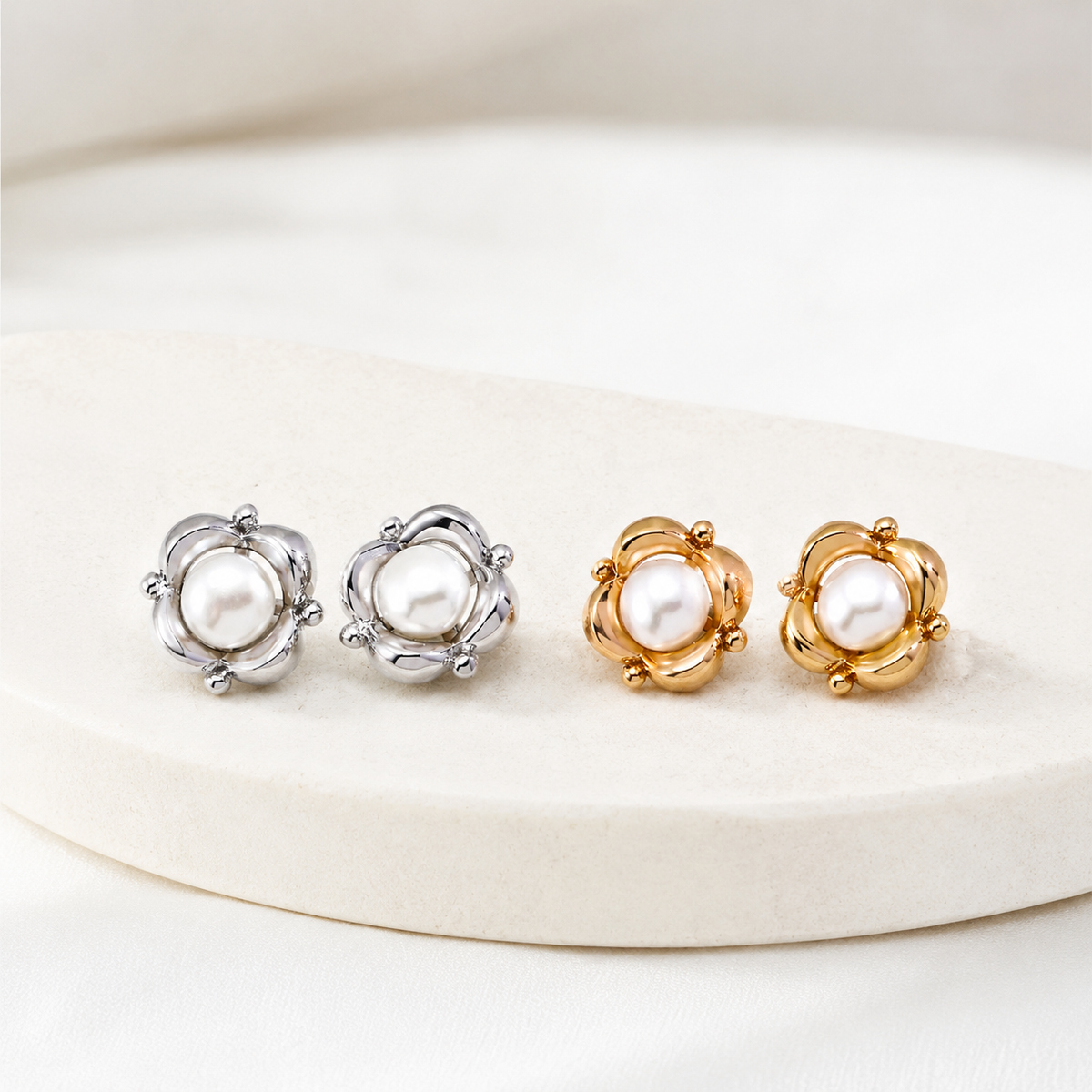 Vintage Gold and Silver Orbit Pearl Stud Earrings shown together on an ivory display