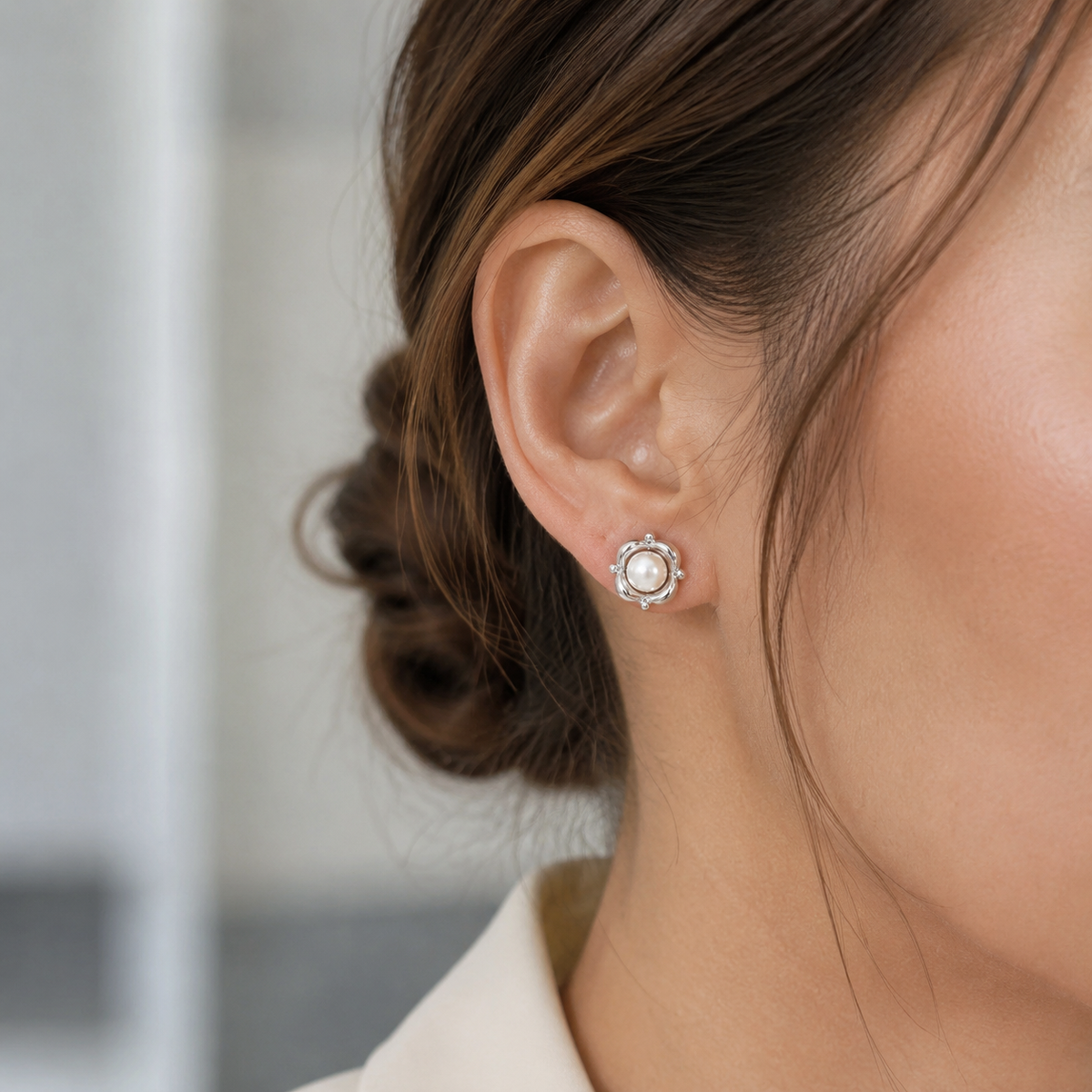 Close ear view of the Silver Orbit Pearl Stud Earring