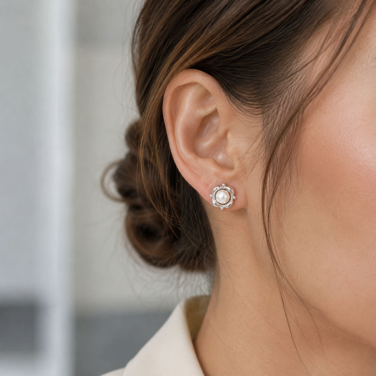 Close ear view of the Silver Orbit Pearl Stud Earring