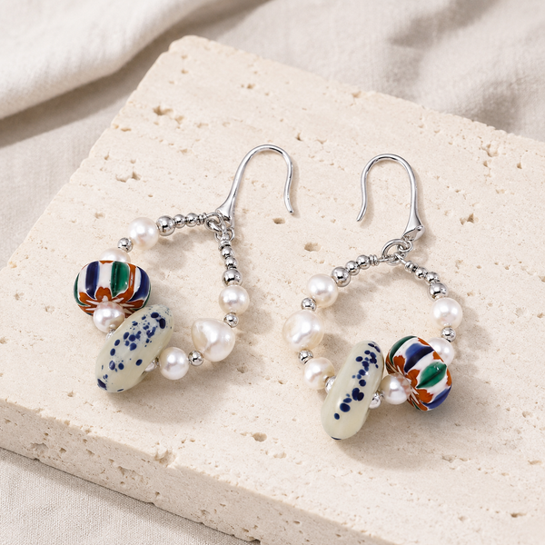 Silver Himalayan Glass Pearl Hoop Earrings on a natural ivory stone display