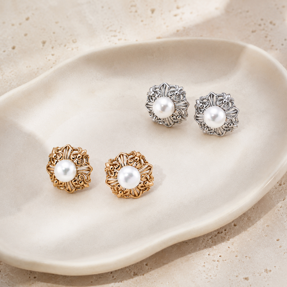 Vintage Gold and Silver Ornate Pearl Stud Earrings shown together in an overhead view