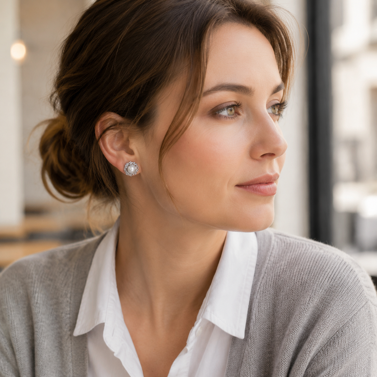 Model wearing Silver Ornate Pearl Stud Earrings with tailored styling