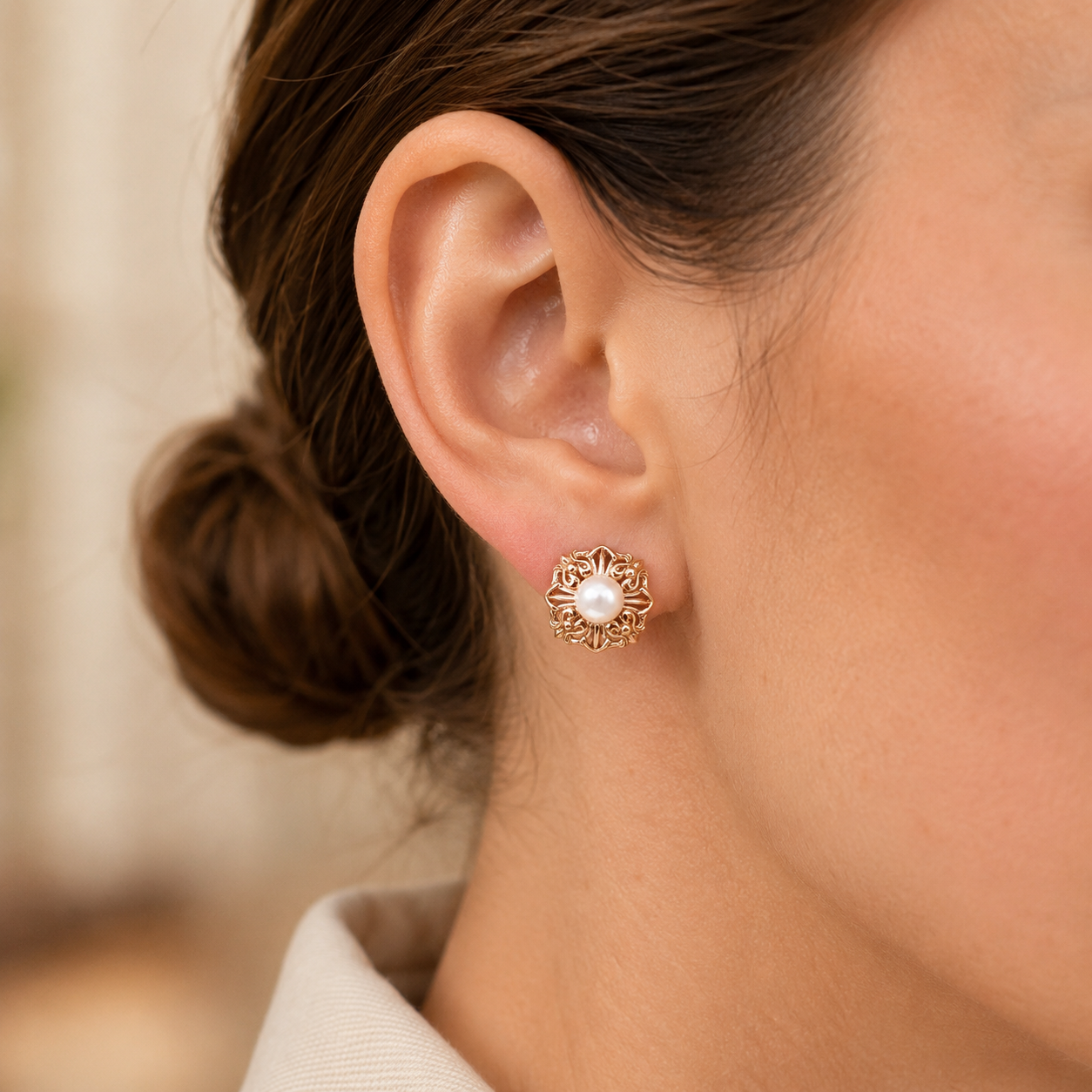 Close ear view of a Vintage Gold Ornate Pearl Stud Earring