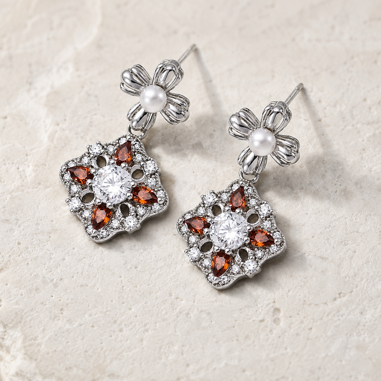 Silver auspicious bloom pearl drop earrings shown as a pair