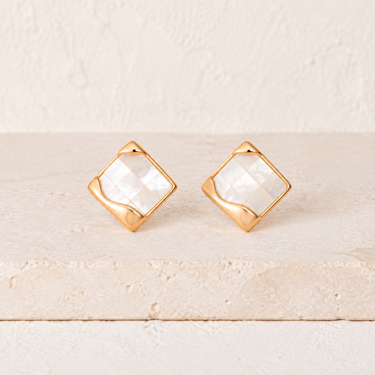 Vintage Gold shell mosaic stud earrings on an ivory display