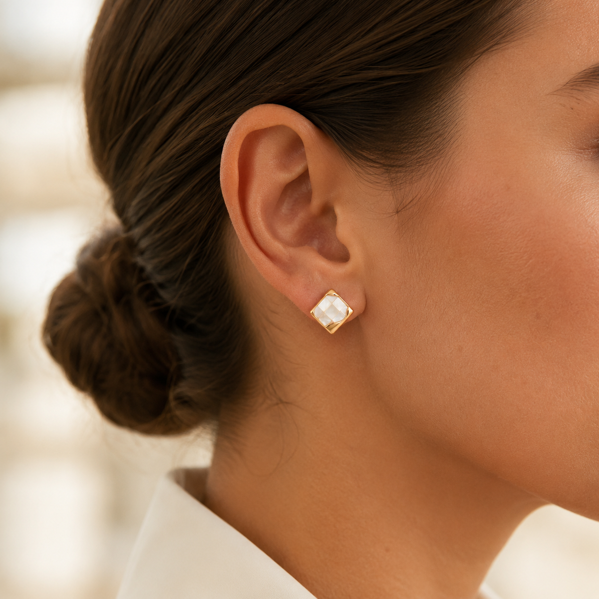 Close ear view of Vintage Gold shell mosaic stud earrings