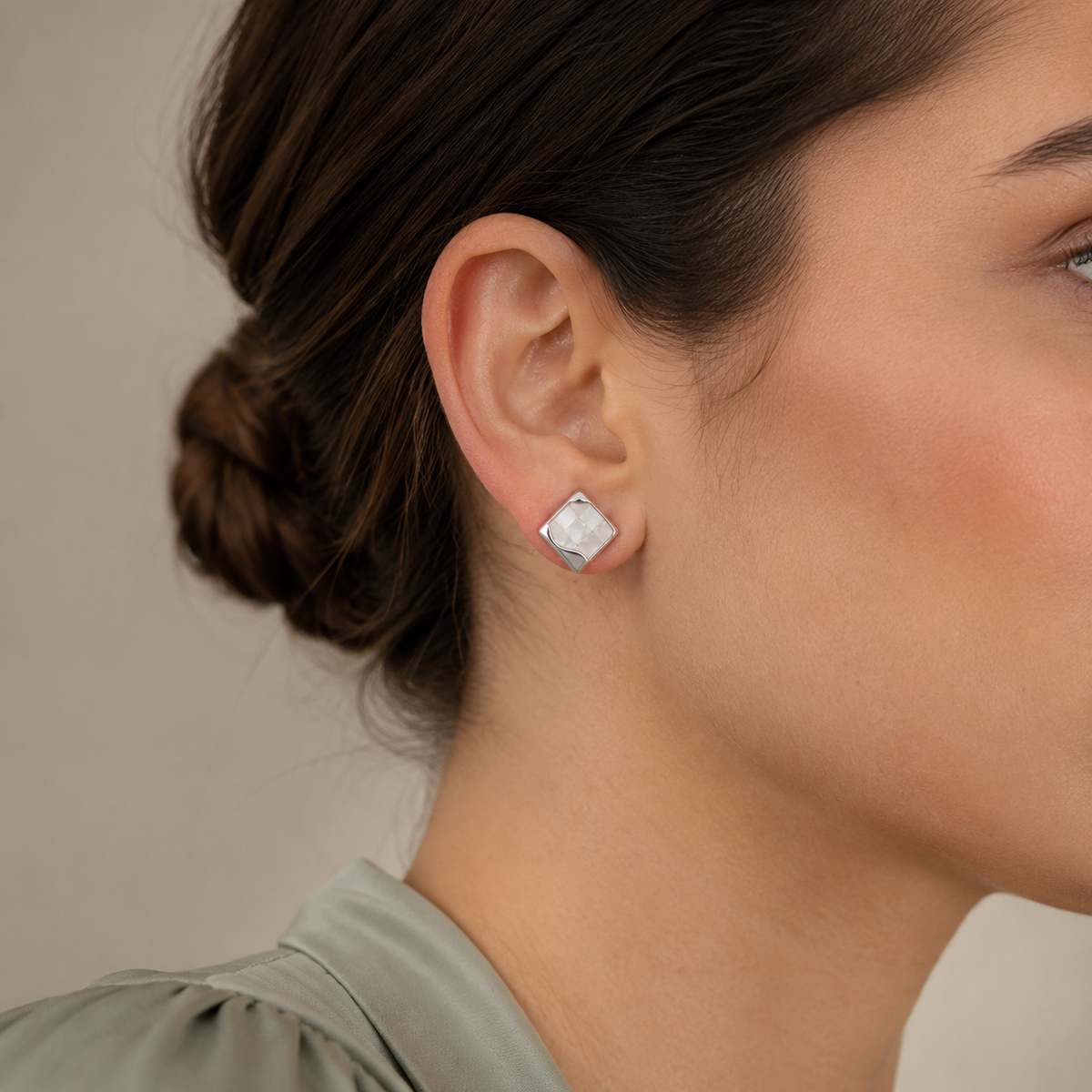 Close ear view of Silver shell mosaic stud earrings