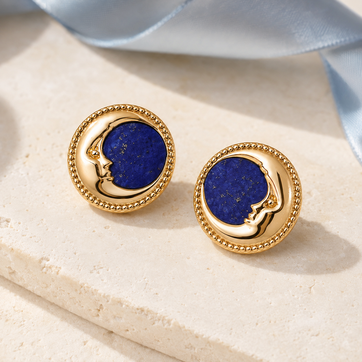 Vintage Gold lapis lazuli moon stud earrings on a stone slab