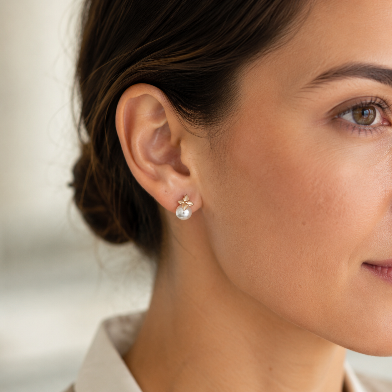 Close ear view of Vintage Gold four-leaf shell pearl stud earrings