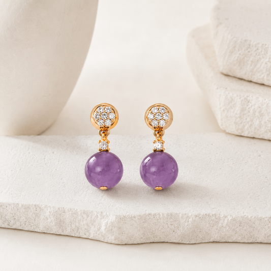 Pair of Vintage Gold Amethyst Drop Earrings with cubic zirconia on an ivory display