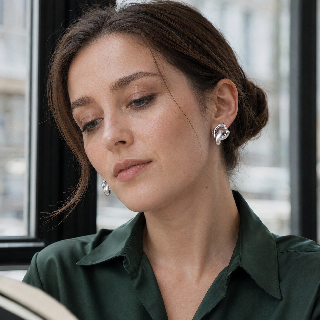 Close ear view of a model wearing Silver Interlocking Zircon Earrings