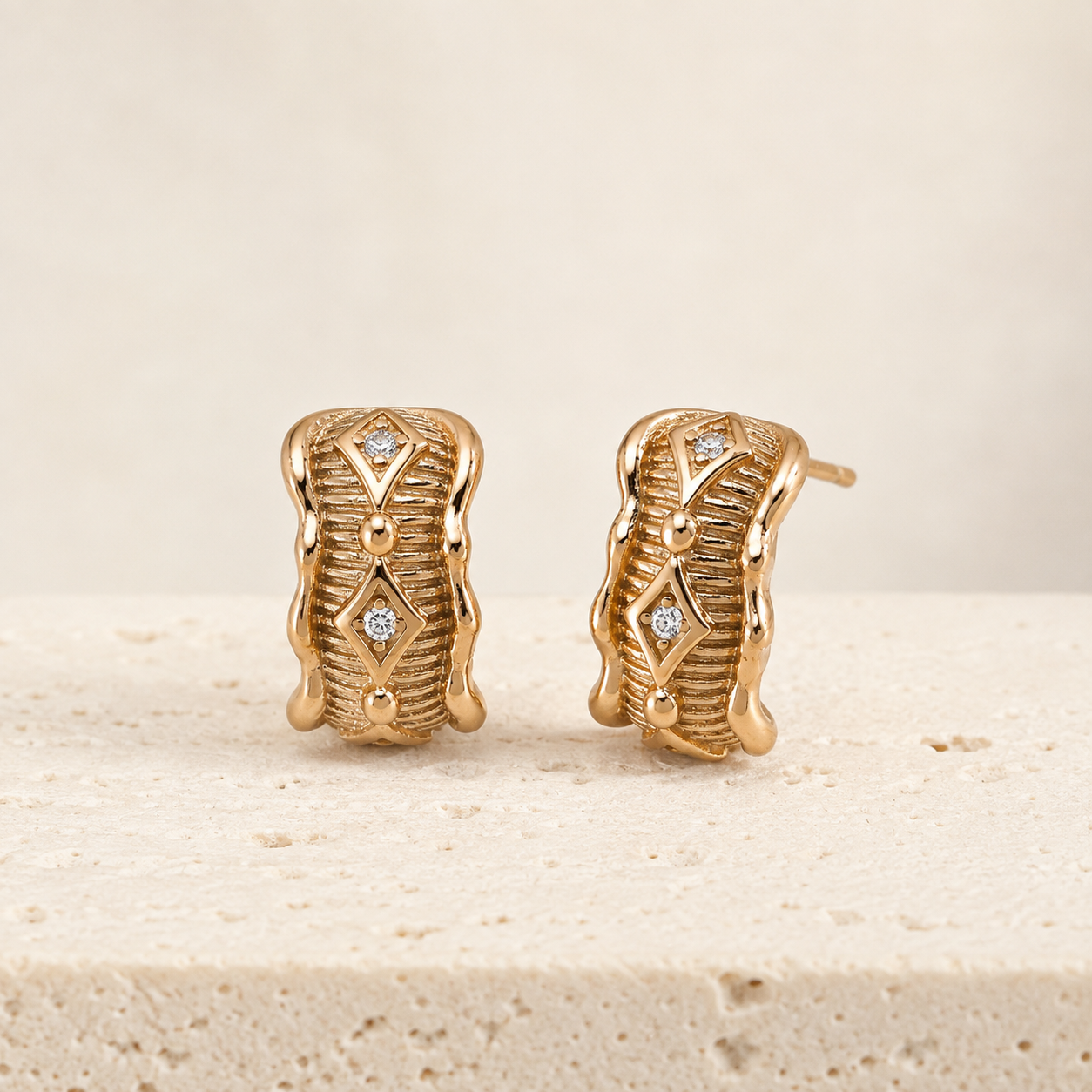 Vintage Gold Vintage Zircon Stud Earrings on a stone display
