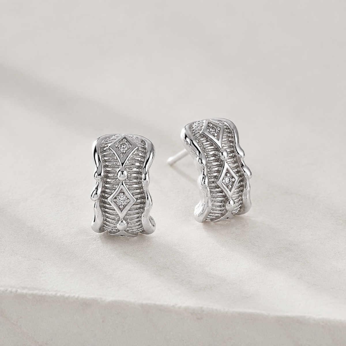 Silver Vintage Zircon Stud Earrings on a stone display