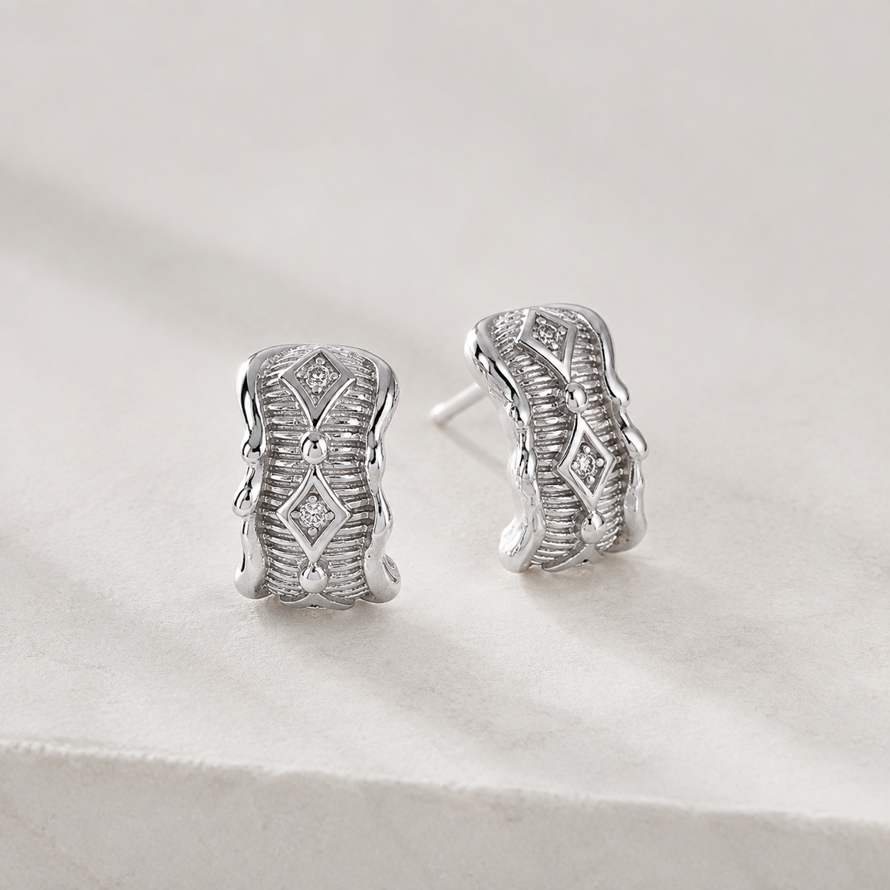 Silver Vintage Zircon Stud Earrings on a stone display