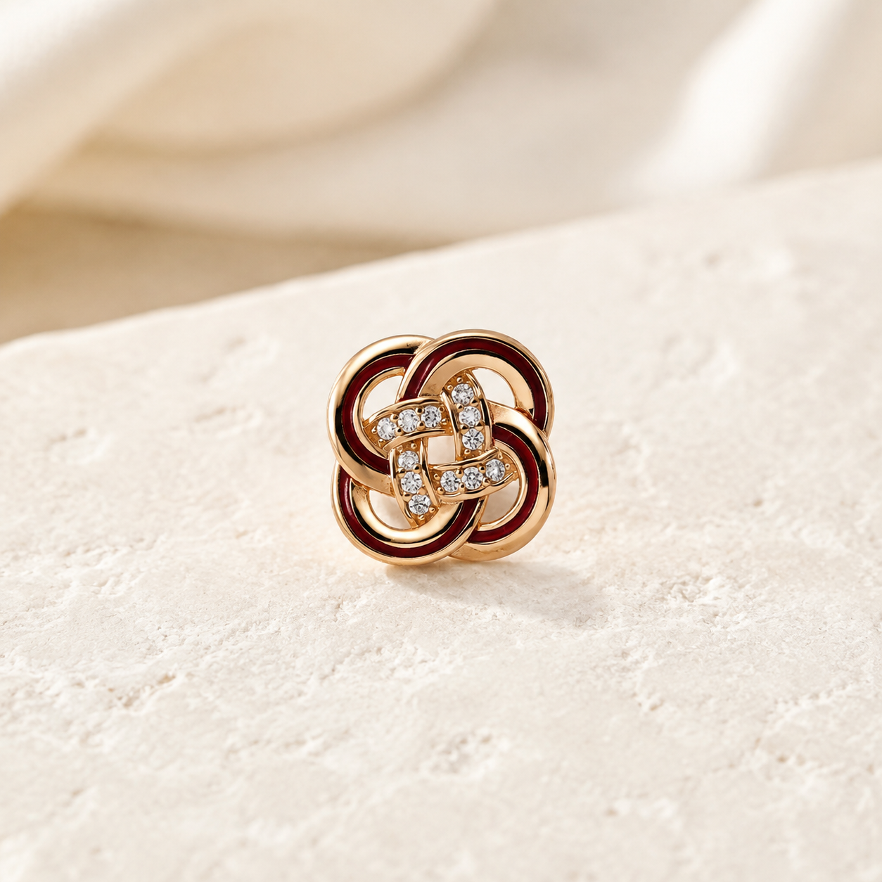 Close view of a Vintage Gold enamel and cubic zirconia knot stud earring