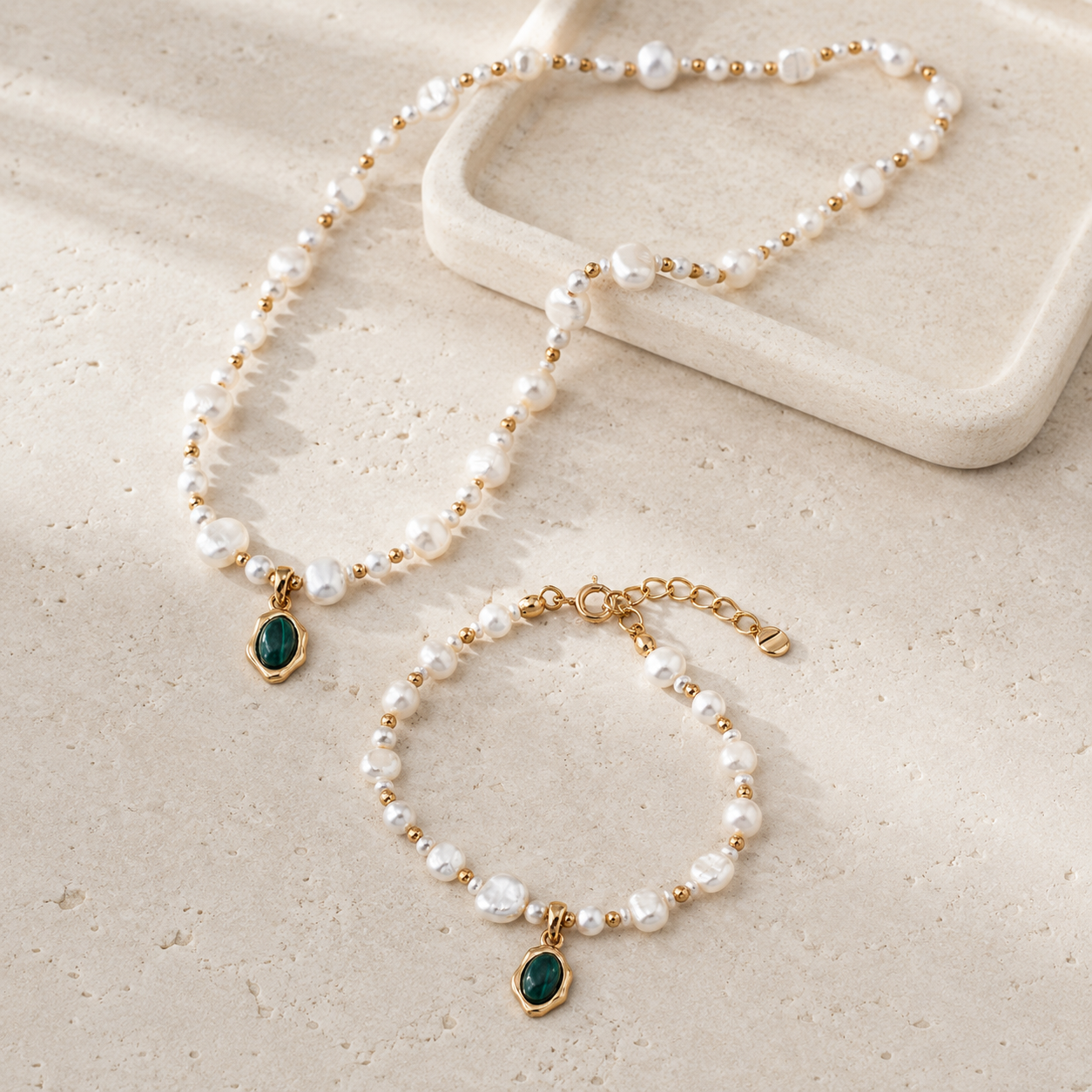 Vintage Gold natural pearl necklace and bracelet set on a stone display