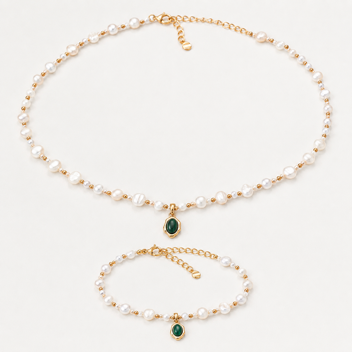 Vintage Gold natural pearl necklace and bracelet jewelry set on an ivory background