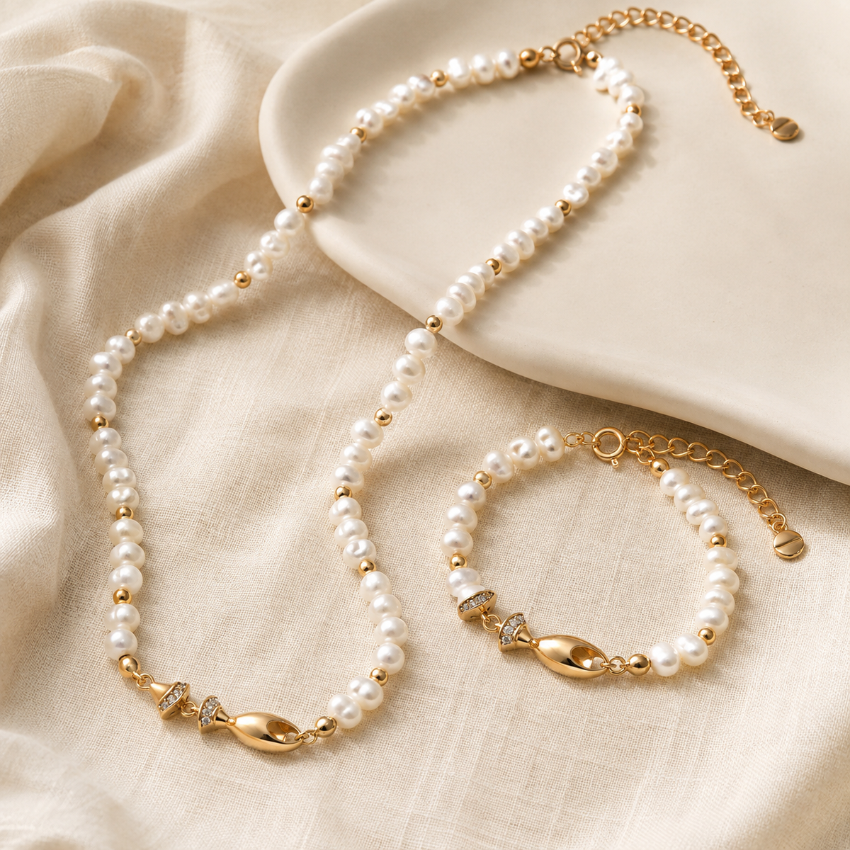 Vintage Gold natural pearl fish necklace and bracelet set on textured fabric